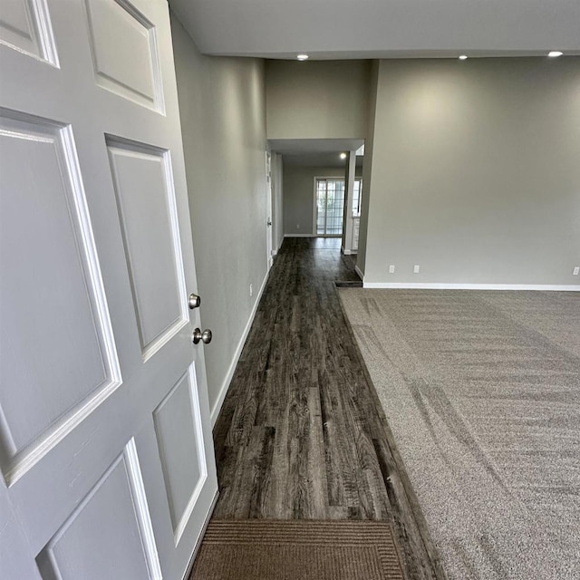 corridor with recessed lighting, baseboards, and dark wood finished floors