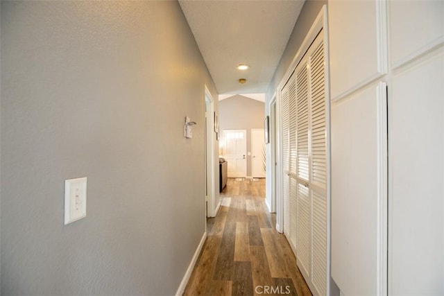 corridor with recessed lighting, baseboards, and wood finished floors