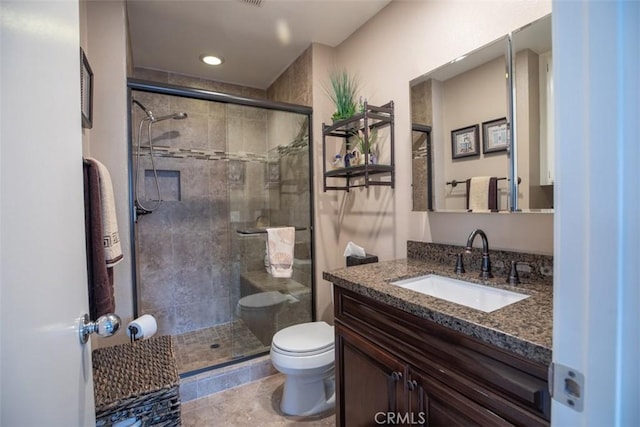 bathroom with vanity, recessed lighting, toilet, and a shower stall