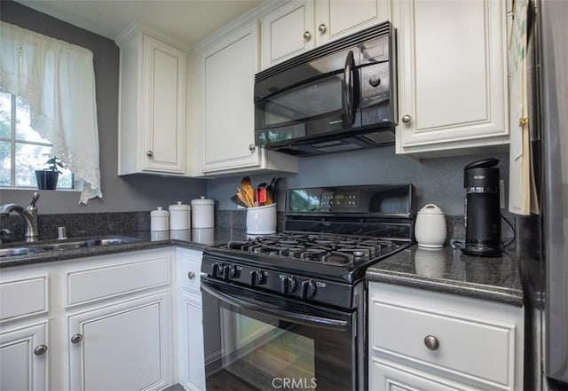 kitchen featuring white cabinets, dark stone counters, a sink, and black appliances