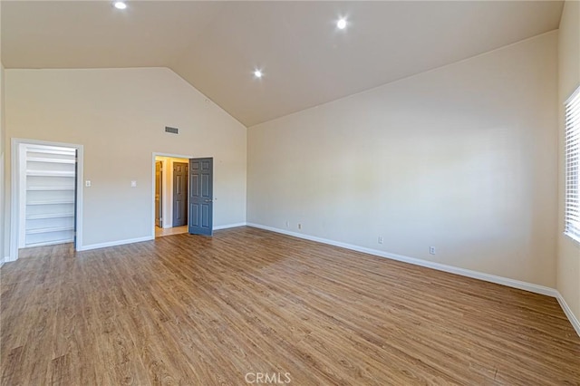 spare room with visible vents, high vaulted ceiling, baseboards, recessed lighting, and light wood-style flooring