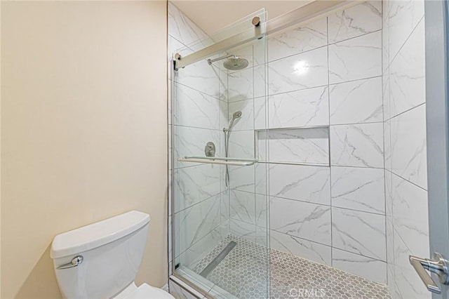 full bathroom with toilet and a stall shower