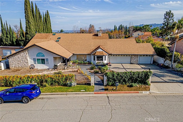single story home featuring a fenced front yard, stone siding, a garage, a gate, and driveway