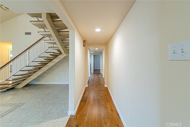 hall with stairs, recessed lighting, baseboards, wood finished floors, and visible vents