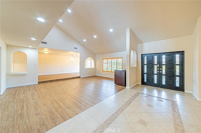 entrance foyer featuring baseboards, recessed lighting, visible vents, and high vaulted ceiling