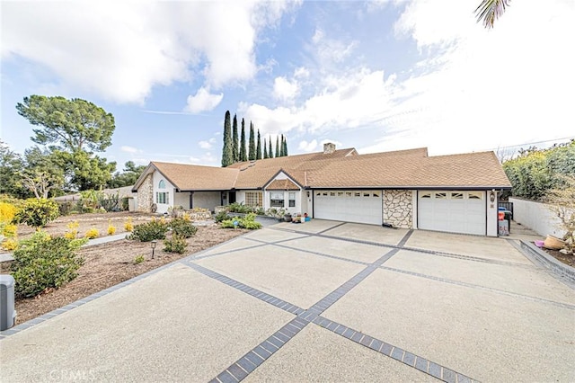 ranch-style home with fence, driveway, a chimney, and a garage