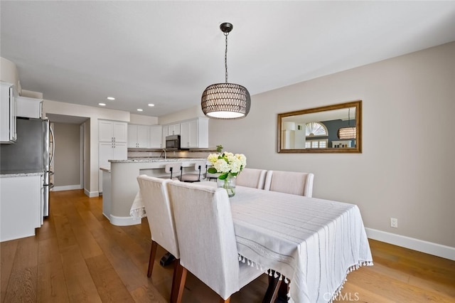 dining area with baseboards, recessed lighting, and hardwood / wood-style flooring