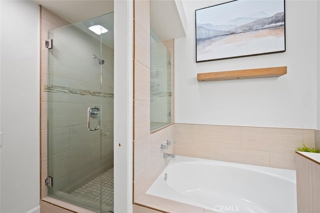 full bathroom with a stall shower and a bath