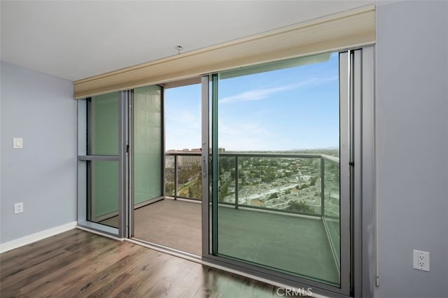 entryway with baseboards, floor to ceiling windows, and wood finished floors