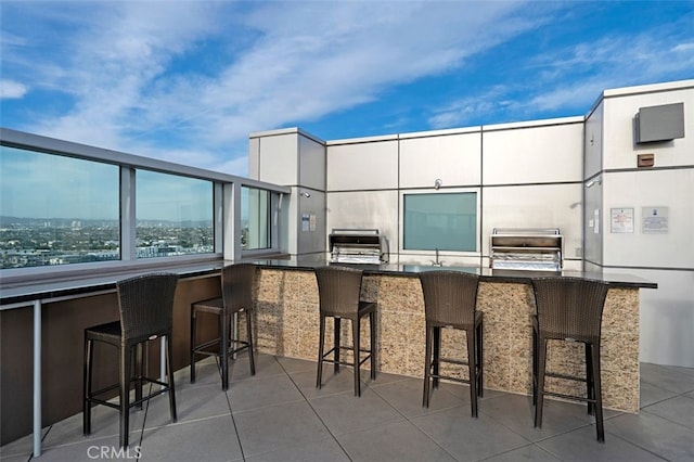 view of patio with outdoor wet bar and exterior kitchen