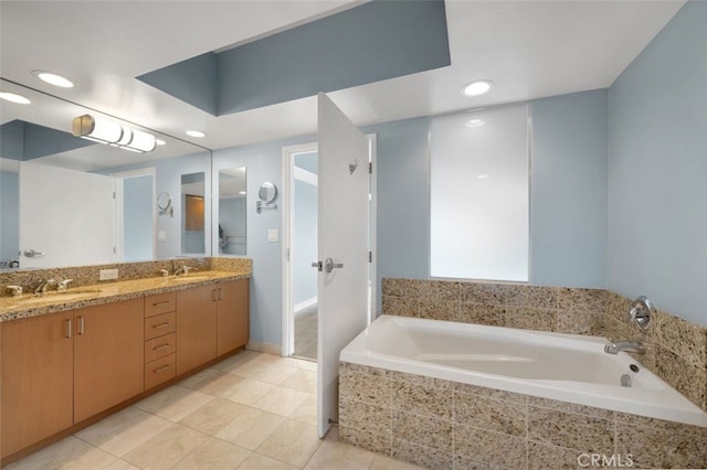 bathroom featuring double vanity, recessed lighting, a bath, tile patterned floors, and a sink