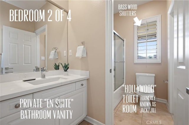 473 Periwinkle St, Fullerton, CA 92835 - full bathroom featuring toilet, vanity, tile patterned flooring, shower / bath combination with glass door, and baseboards