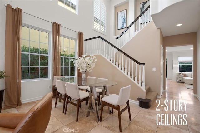 473 Periwinkle St, Fullerton, CA 92835 - tiled dining space with a high ceiling, healthy amount of natural light, stairs, and baseboards