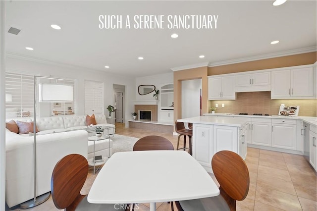 473 Periwinkle St, Fullerton, CA 92835 - dining area with ornamental molding, recessed lighting, light tile patterned flooring, and a fireplace with raised hearth