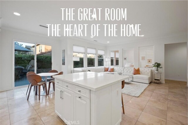 473 Periwinkle St, Fullerton, CA 92835 - kitchen with crown molding, plenty of natural light, a center island, recessed lighting, and white cabinetry