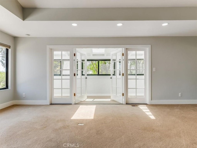 entryway featuring carpet floors, baseboards, and french doors