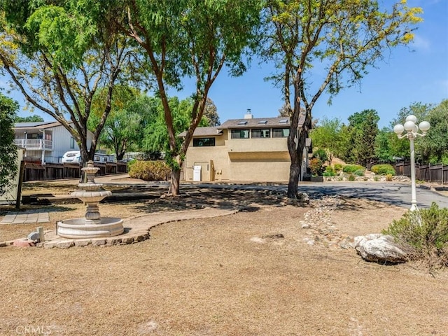 rear view of house featuring fence