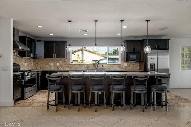 2485 W Westward Ave, Banning, CA 92220 - kitchen with stainless steel appliances, wall chimney exhaust hood, plenty of natural light, decorative backsplash, and recessed lighting
