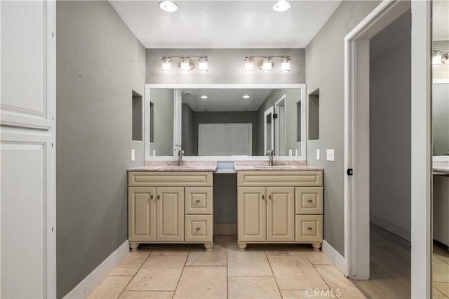 2485 W Westward Ave, Banning, CA 92220 - full bathroom with double vanity and baseboards