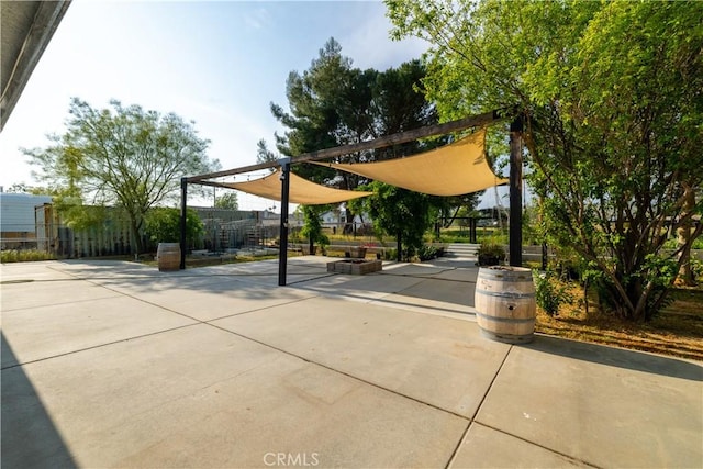 surrounding community with fence and a patio area