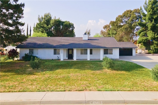2485 W Westward Ave, Banning, CA 92220 - ranch-style home with concrete driveway, an attached garage, a porch, a front yard, and a chimney