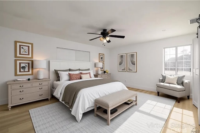 2485 W Westward Ave, Banning, CA 92220 - bedroom featuring wood finished floors, a ceiling fan, and baseboards