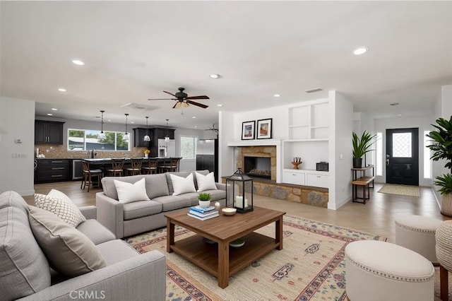 2485 W Westward Ave, Banning, CA 92220 - living room with recessed lighting, ceiling fan, a fireplace with raised hearth, and built in features