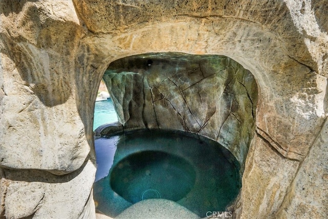 exterior details with a hot tub