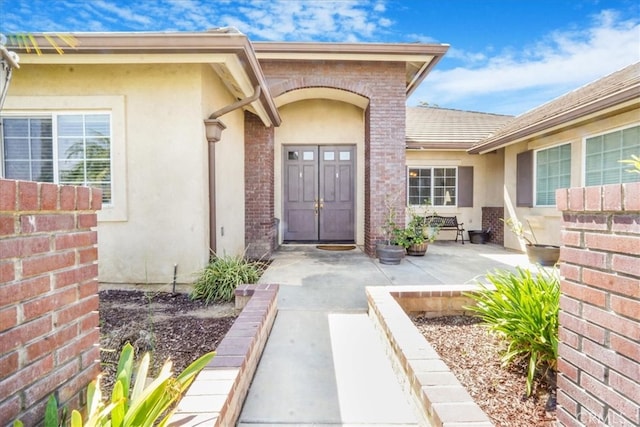property entrance with stucco siding