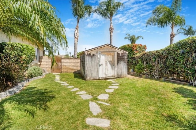 view of shed featuring a gate and a fenced backyard