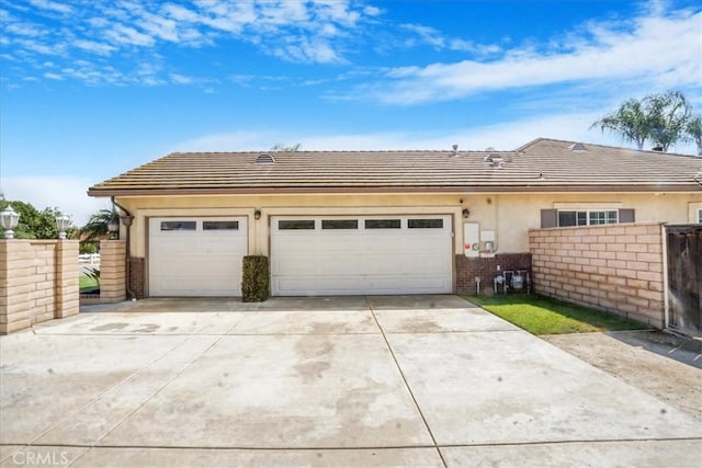 garage with fence and driveway