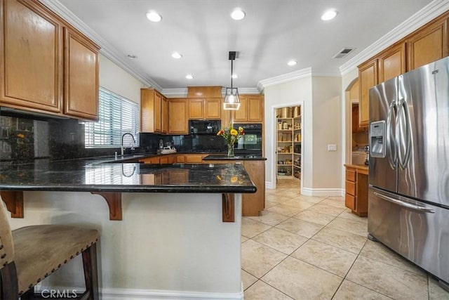 kitchen with crown molding, backsplash, black appliances, and a peninsula