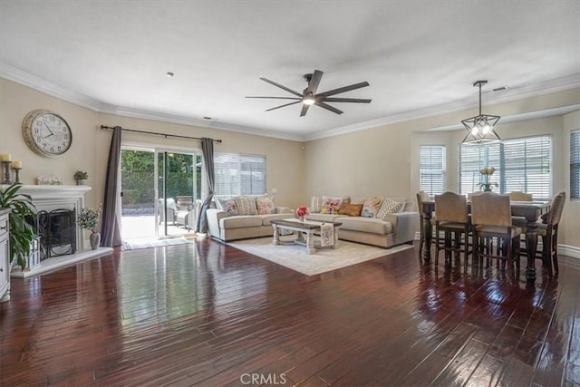 living room with ornamental molding, a ceiling fan, hardwood / wood-style flooring, and visible vents