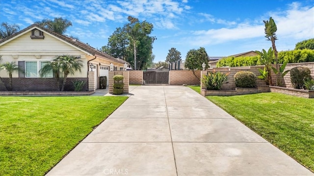 view of yard with concrete driveway, an attached garage, a gate, and fence private yard