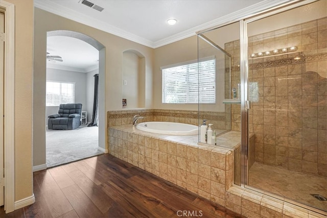 full bathroom featuring a shower stall, a garden tub, visible vents, ornamental molding, and hardwood / wood-style flooring