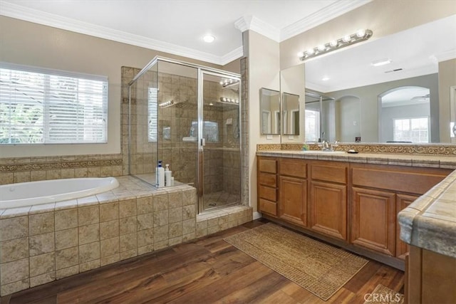 full bath with a garden tub, ornamental molding, a stall shower, and vanity