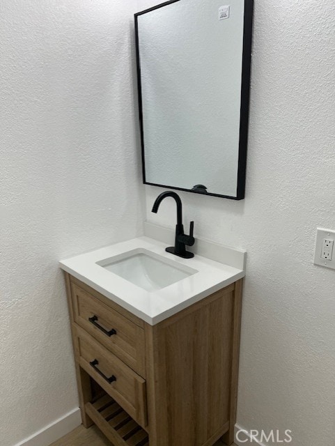 10065 Tudor Ave, Montclair, CA 91763 - bathroom with vanity and baseboards
