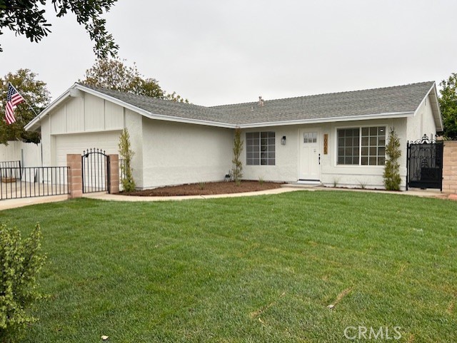 10065 Tudor Ave, Montclair, CA 91763 - ranch-style house with a garage, a gate, and a front lawn