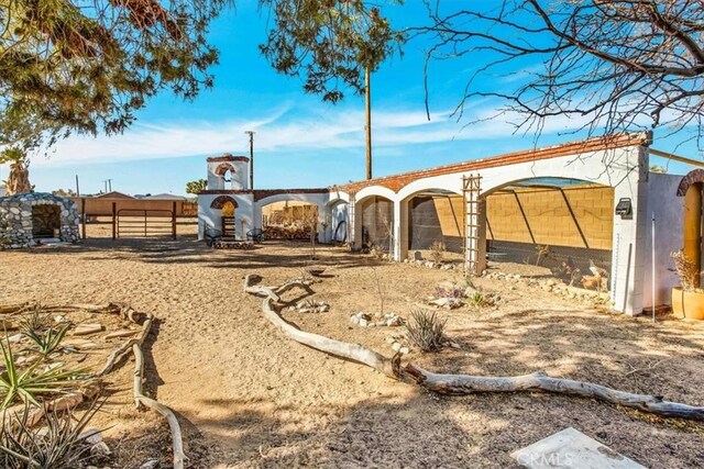 4796 Camarilla Ave, Yucca Valley, CA 92284 - view of yard with fence, exterior structure, and an outbuilding