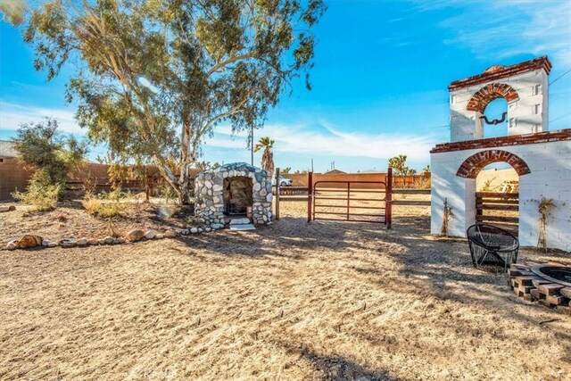 4796 Camarilla Ave, Yucca Valley, CA 92284 - fenced backyard with an outdoor fire pit