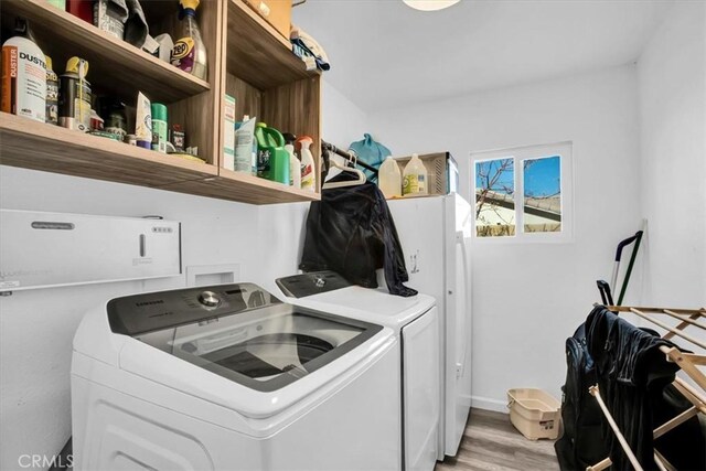 4796 Camarilla Ave, Yucca Valley, CA 92284 - laundry room with washer and dryer, light wood finished floors, and baseboards