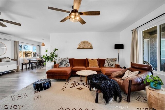 4796 Camarilla Ave, Yucca Valley, CA 92284 - living room featuring a ceiling fan, wood finished floors, and an AC wall unit