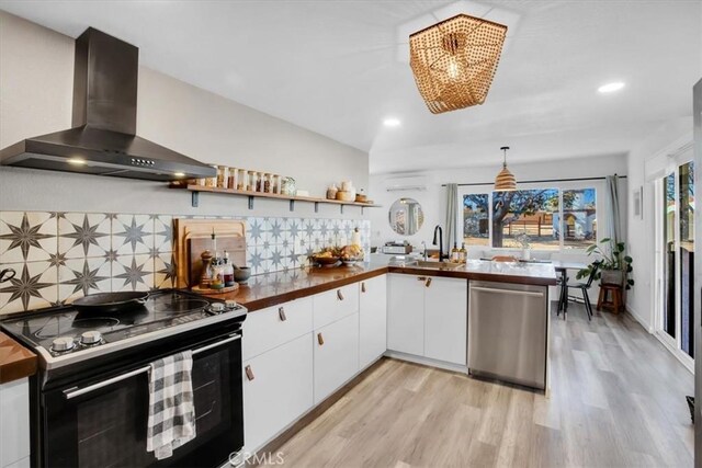 4796 Camarilla Ave, Yucca Valley, CA 92284 - kitchen featuring black electric range oven, stainless steel dishwasher, wall chimney range hood, light wood-style flooring, and recessed lighting