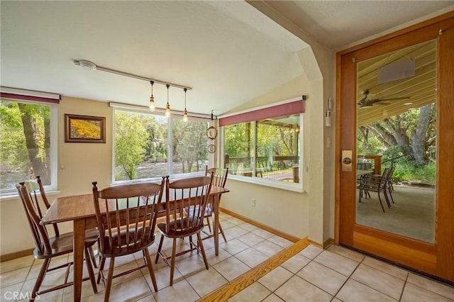dining space featuring track lighting, baseboards, ceiling fan, and light tile patterned flooring