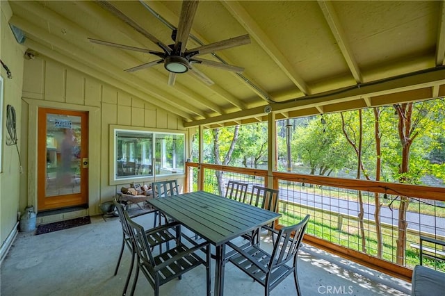 sunroom / solarium featuring outdoor dining space, ceiling fan, and a healthy amount of sunlight