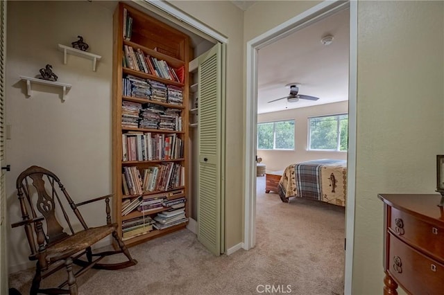sitting room featuring ceiling fan and light colored carpet