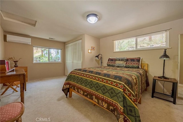 bedroom featuring attic access, visible vents, a wall mounted AC, a closet, and carpet