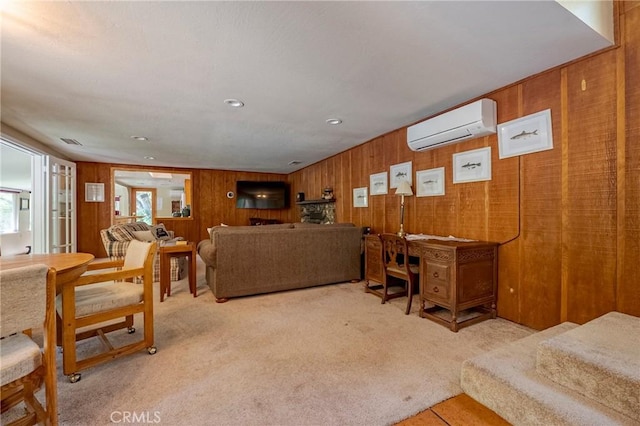 carpeted living area with wooden walls, visible vents, and a wall mounted air conditioner