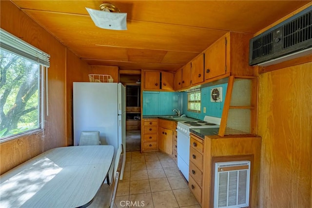 kitchen with white appliances, a sink, visible vents, and a wealth of natural light