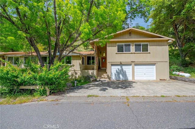 tri-level home featuring driveway and a garage